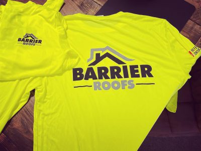 Yellow Barrier Roofs t-shirts sitting on table