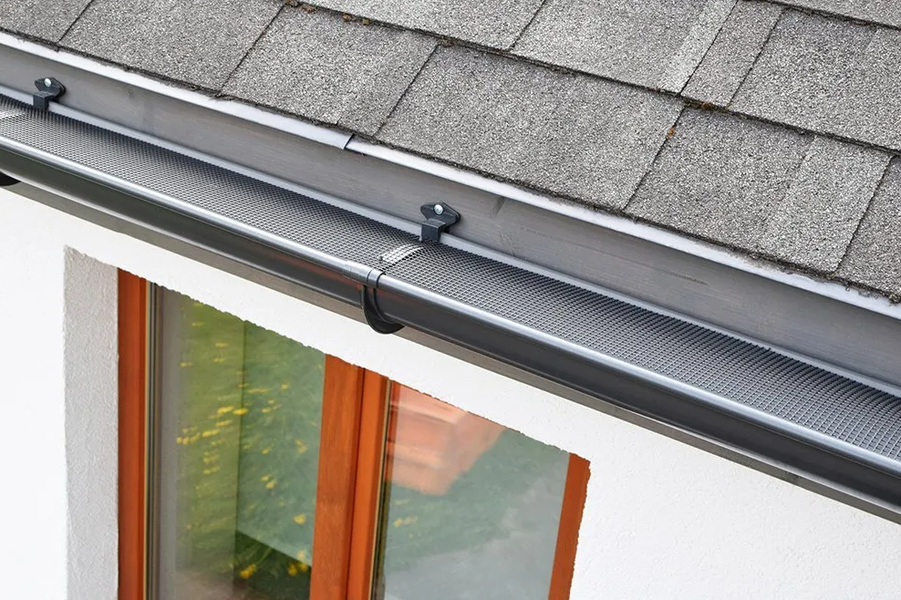New gutter install showing black gutter protection from leaves