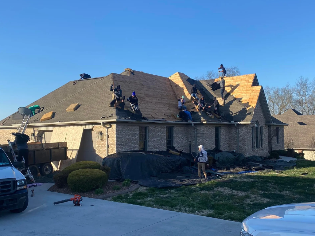 Barrier Roofs team members installing new shingles on home roof in Somerset, KY