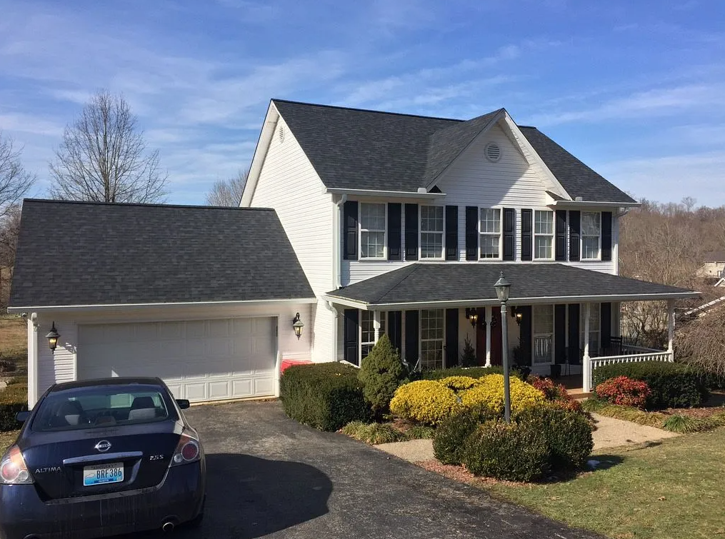 Home showing roof with black shingles and gutter replacements in London, KY