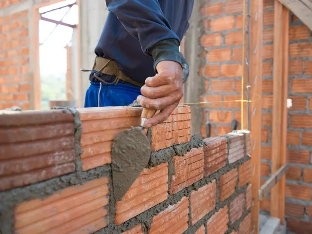 Man competing home masonry work on bricks